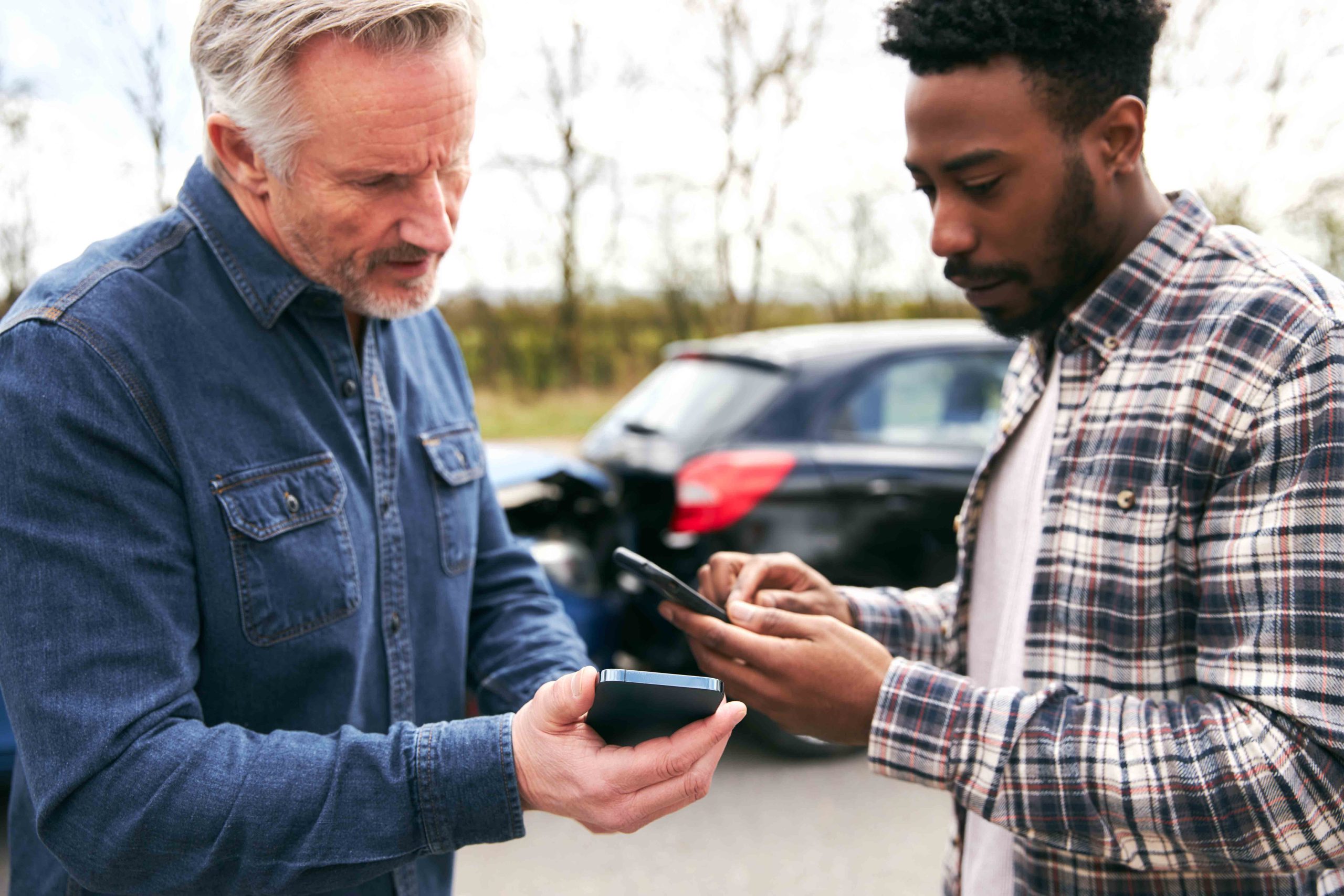 A driver exchanging information with another driver after a car accident