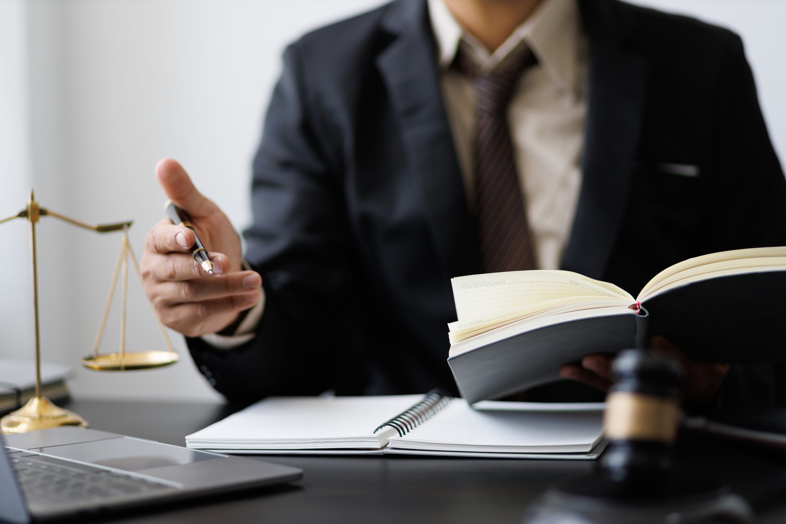 An Uber accident lawyer in a suit discussing legal documents with a client during a meeting