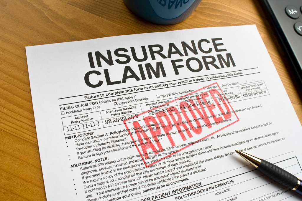 Approved insurance claim form on a desk with a pen, emphasizing the goal of securing maximum compensation for accident-related expenses and losses