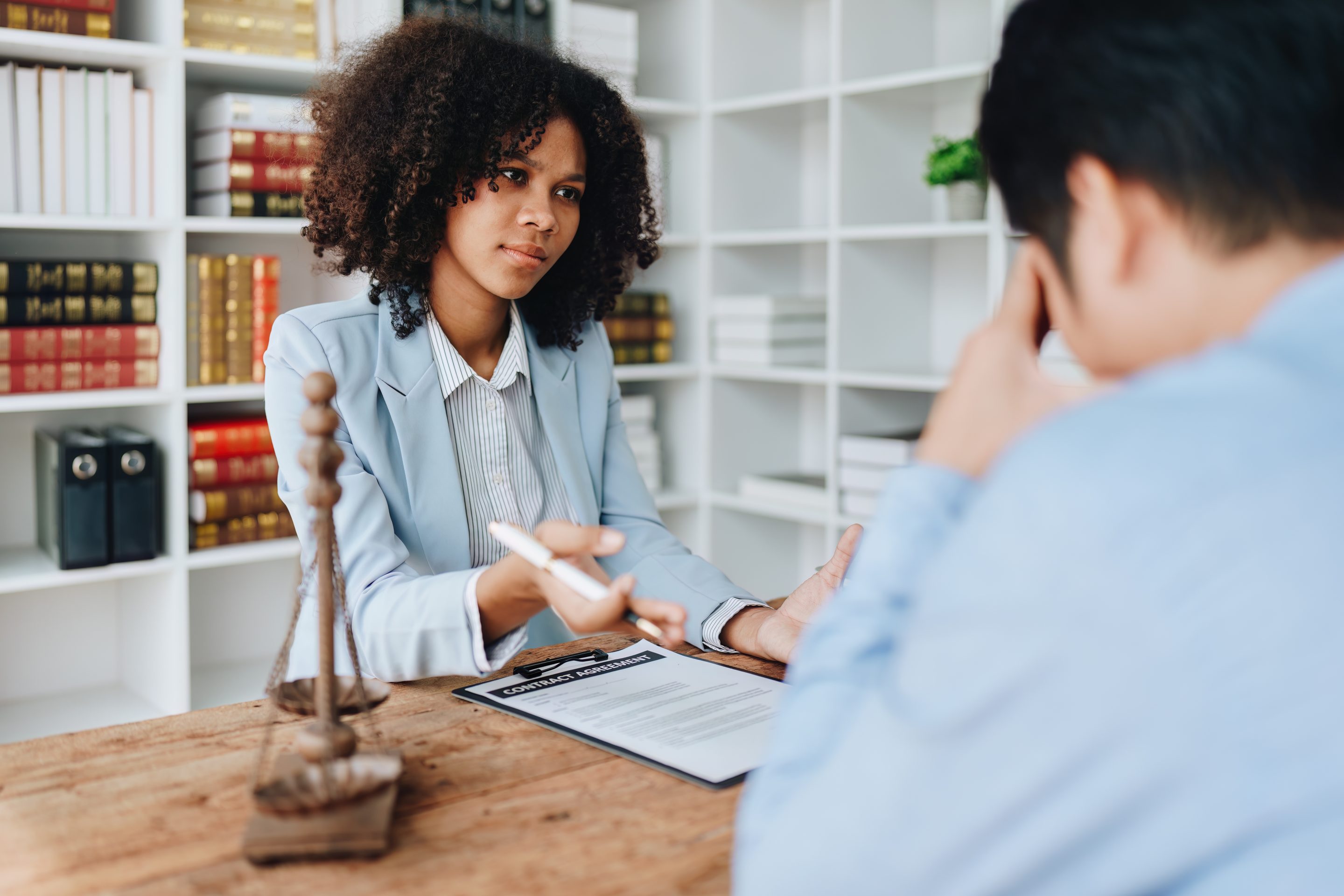 A lawyer converses with a client, both appearing concerned after a hit-and-run incident