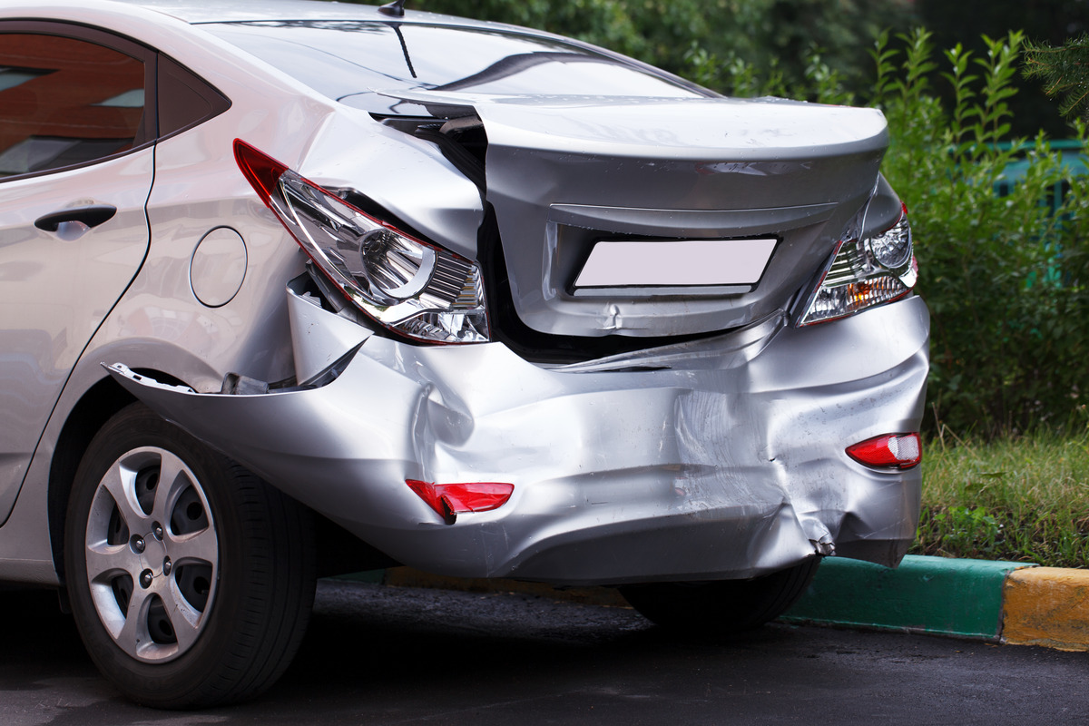 zoomed in photo of an insurance claim with a toy car representing rental car insurance claim