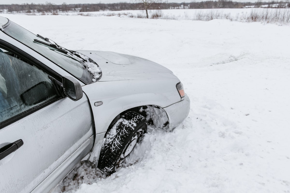 A car driving on the snow highlighting hazardous road conditions and potential for accidents