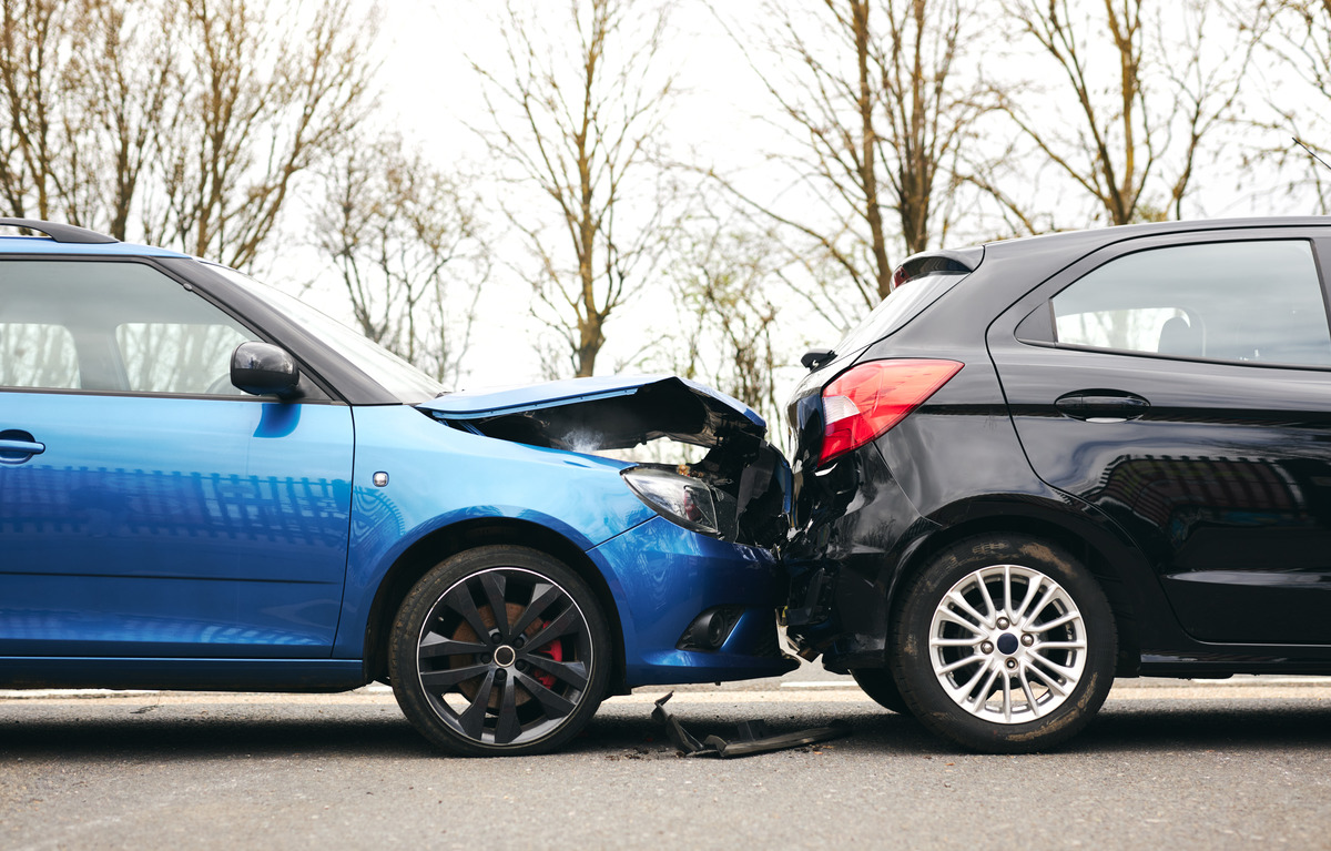 Damaged cars in a parking lot after a collision, showcasing the aftermath of a car accident