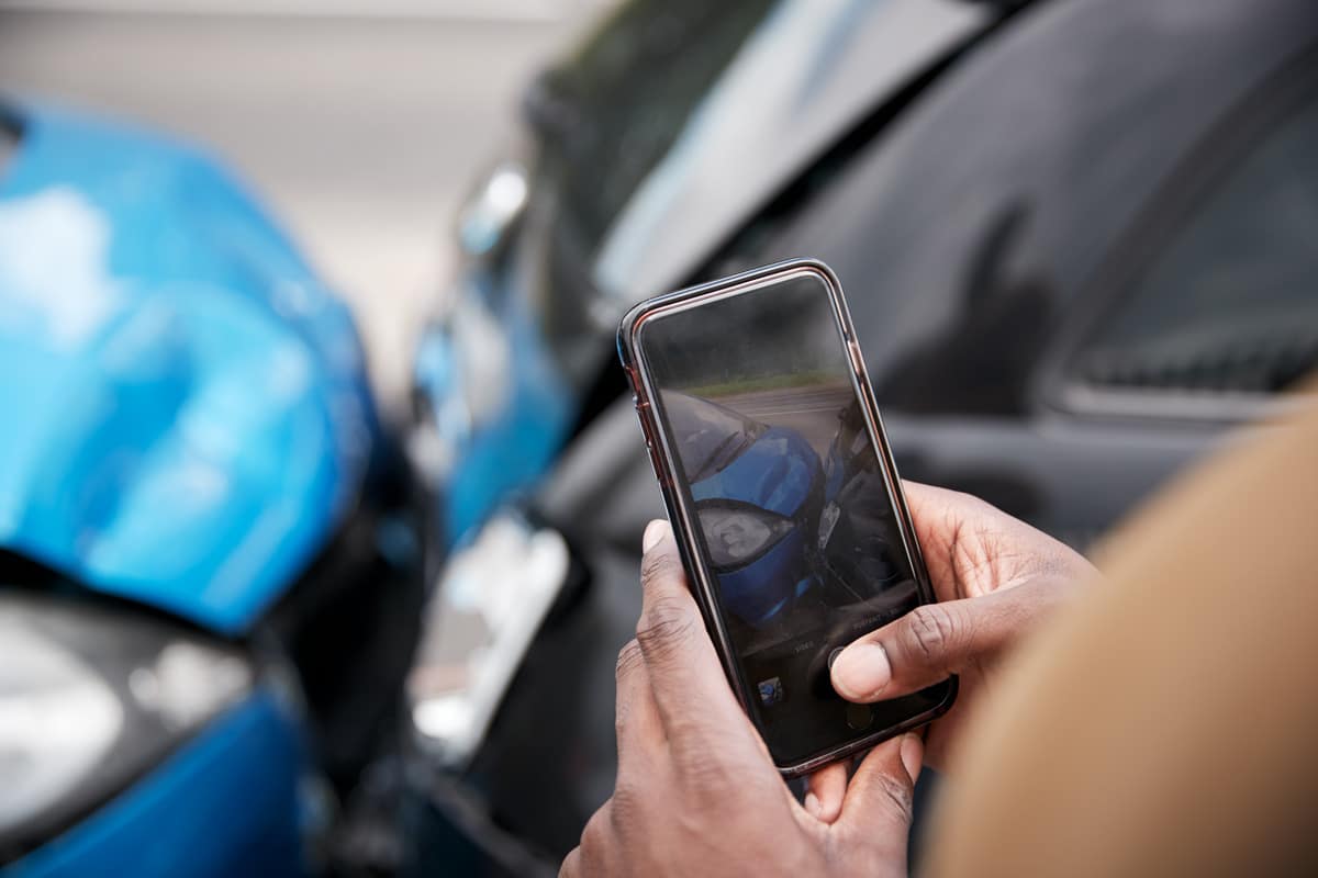 a person taking a photo of a rear-end collision accident