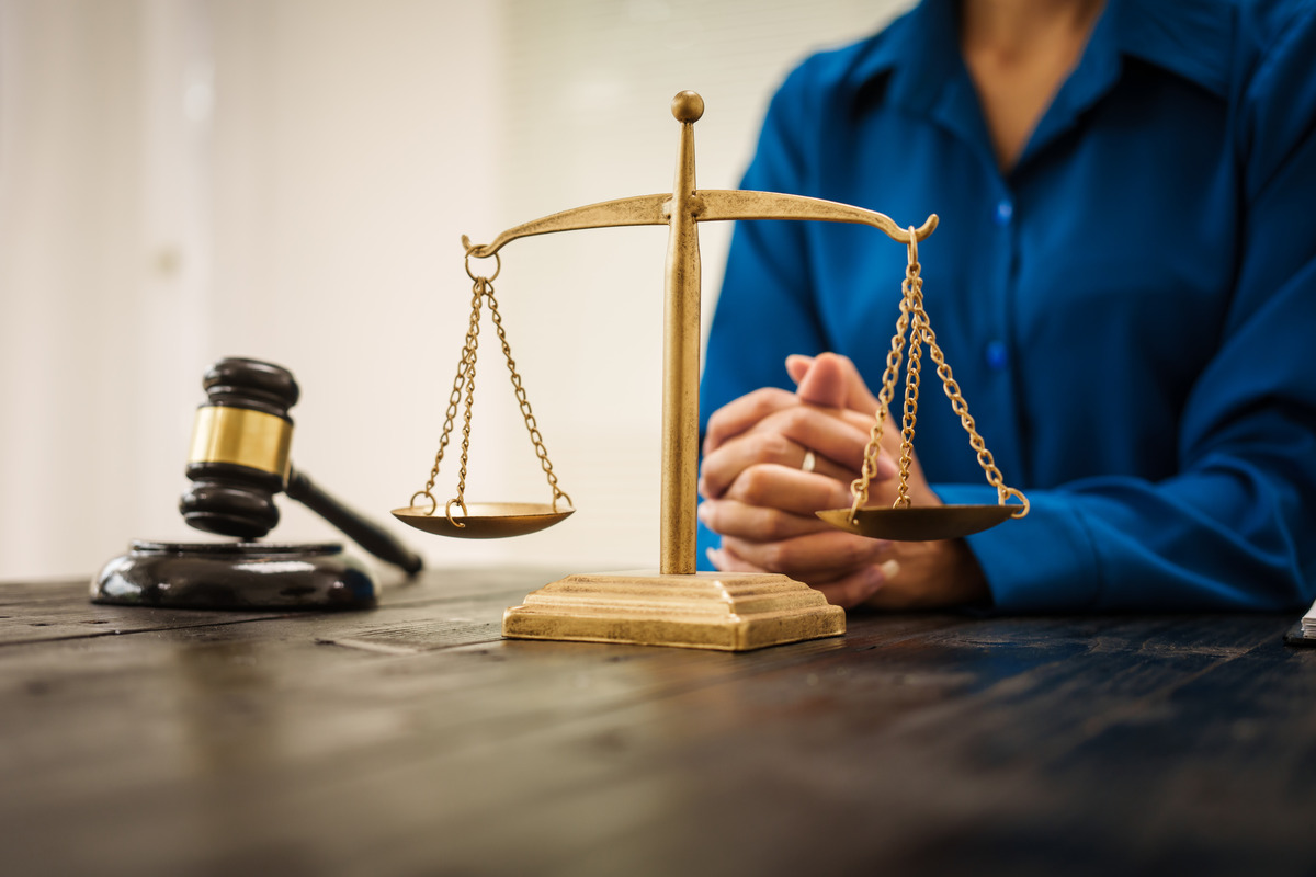 A gavel with a lawsuit document on a table