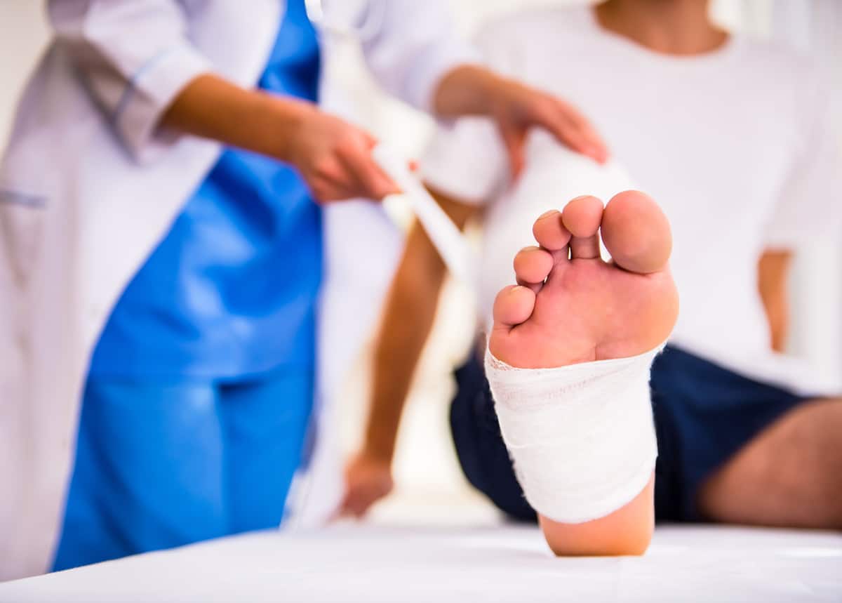 Doctor helping a patient with a fractured leg