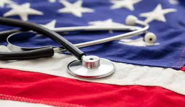A stethoscope on an American Flag, symbolizing US Health Care