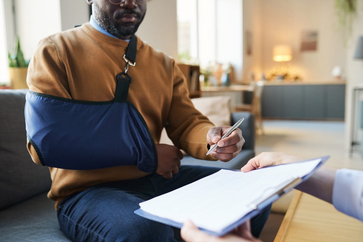 An Injured Man signing documents