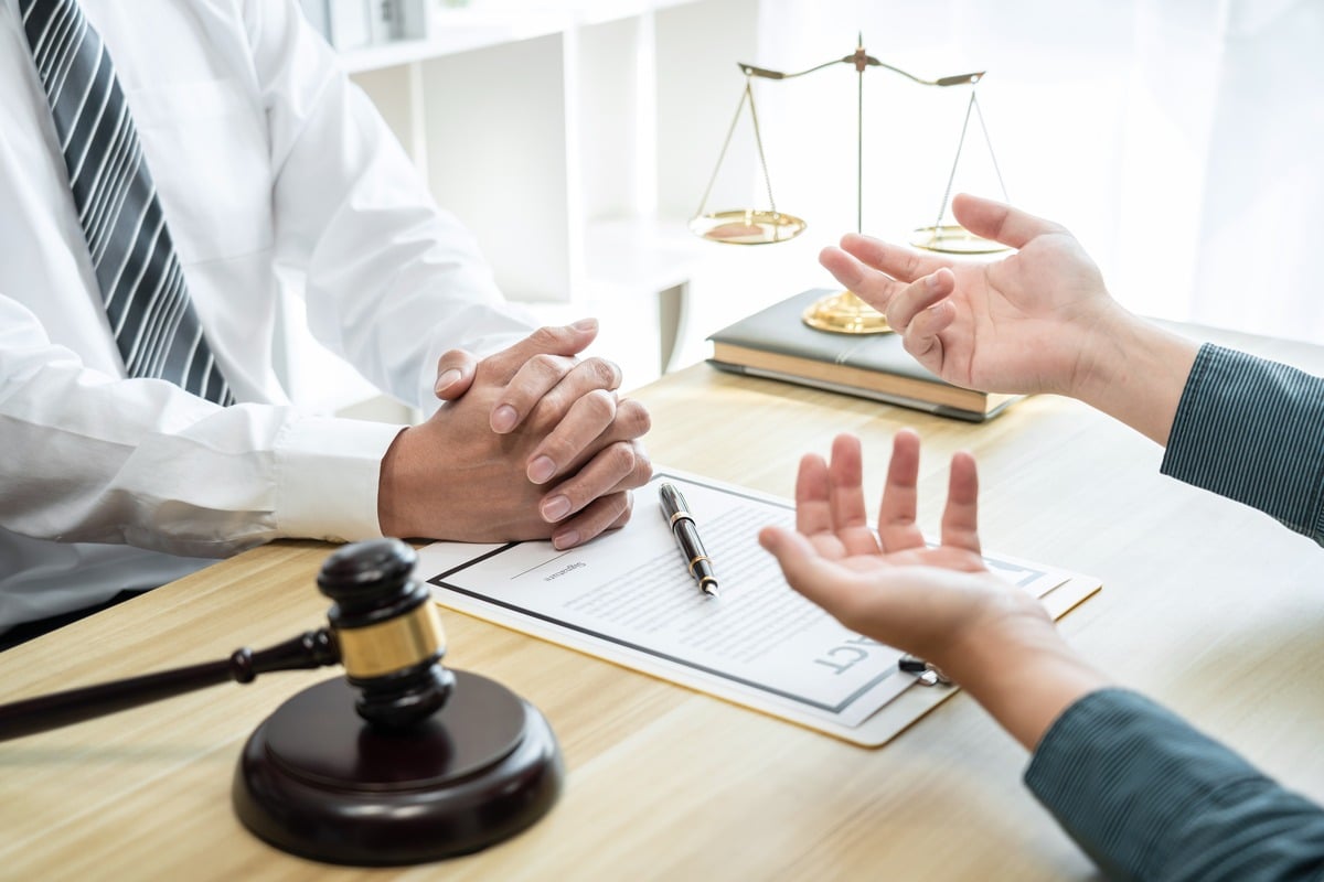 A lawyer listens while the client tells what happen on the car accident
