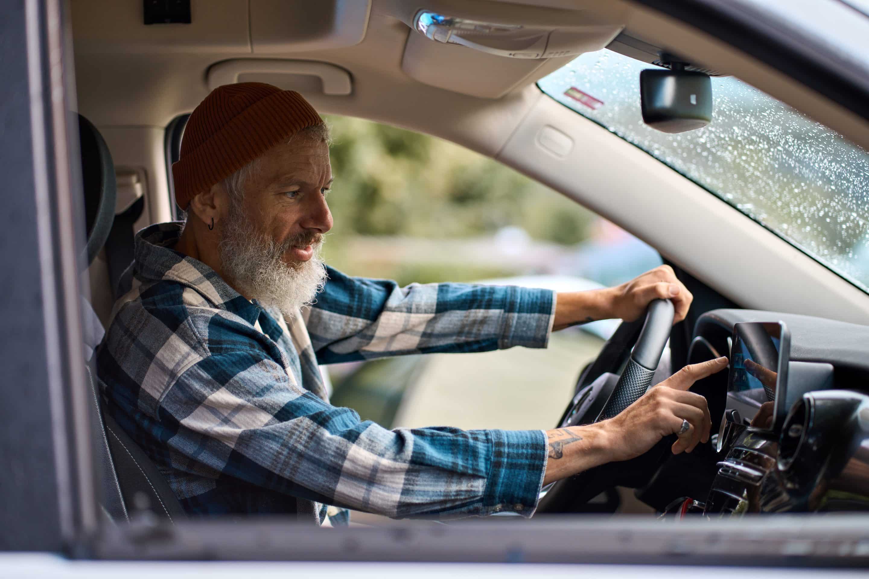 Older Man trying to navigate the roads using GPS from the vehicle