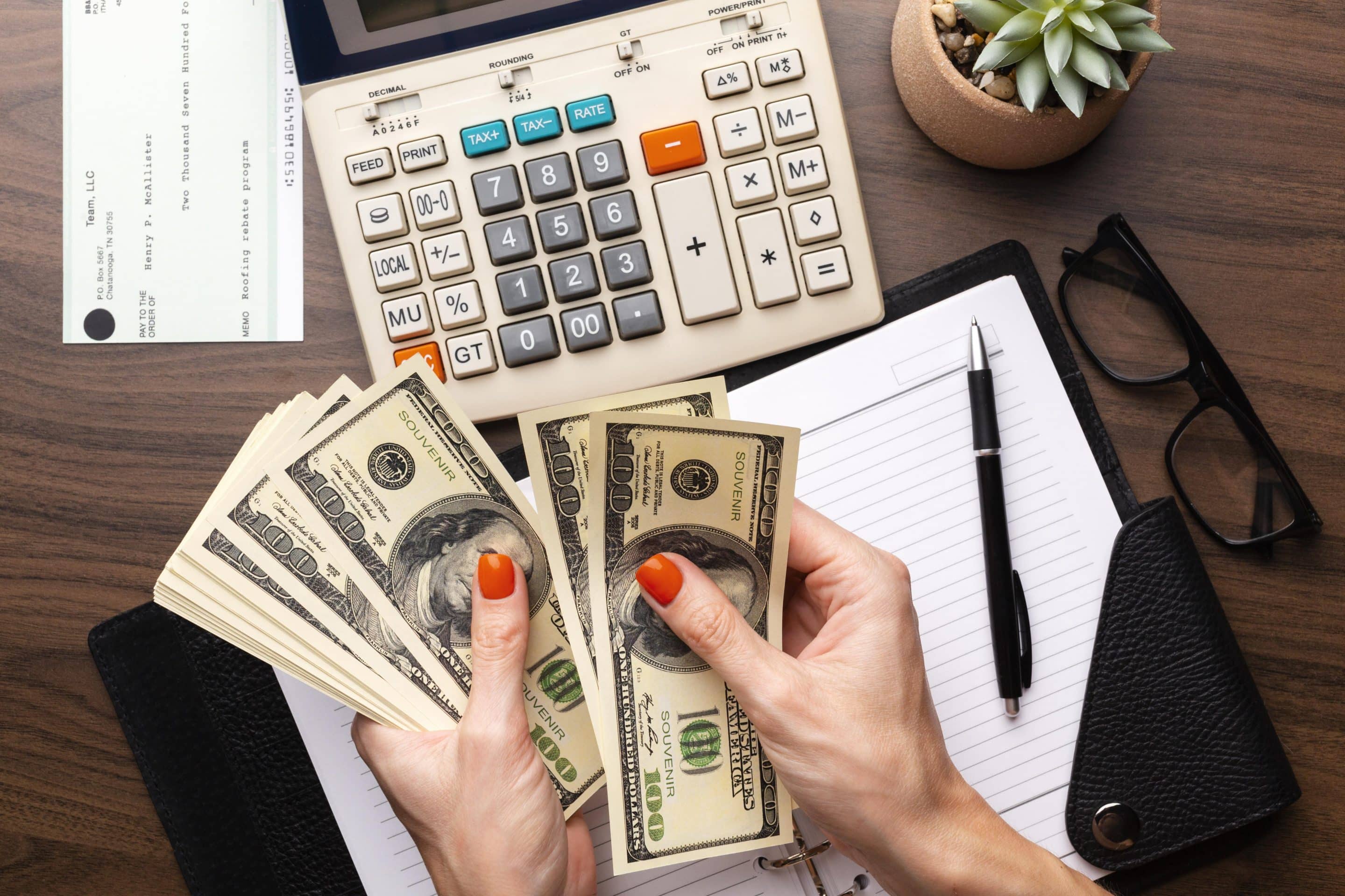 Person’s hands handling cash and counting currency