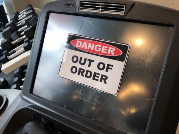 Close-up of a gym treadmill screen displaying a “Danger: Out of Order” sign, indicating equipment maintenance or malfunction