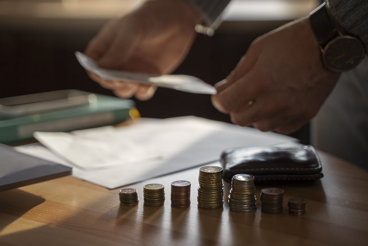 Person’s hands handling cash and counting currency