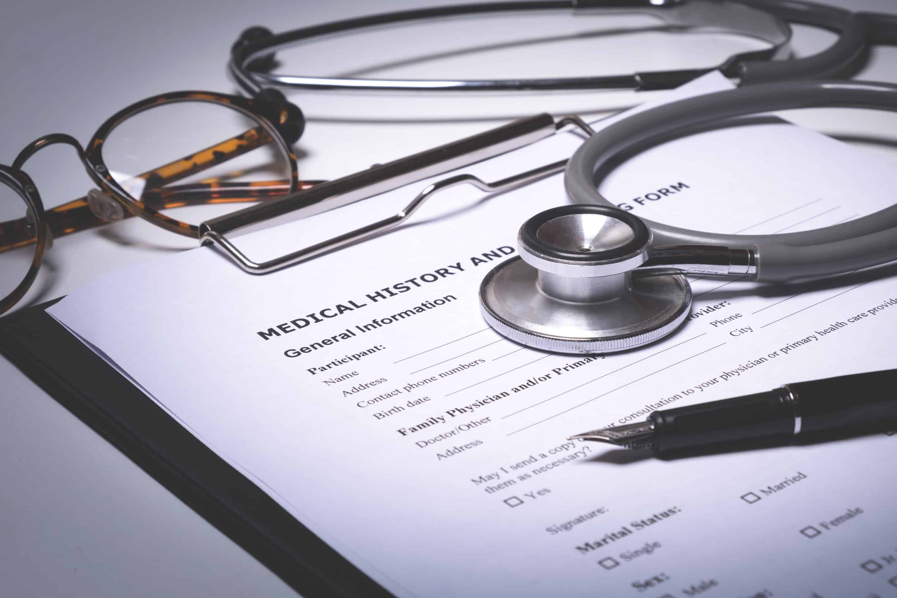 Doctor pointing to a patient's medical record for signature and consent during an office visit