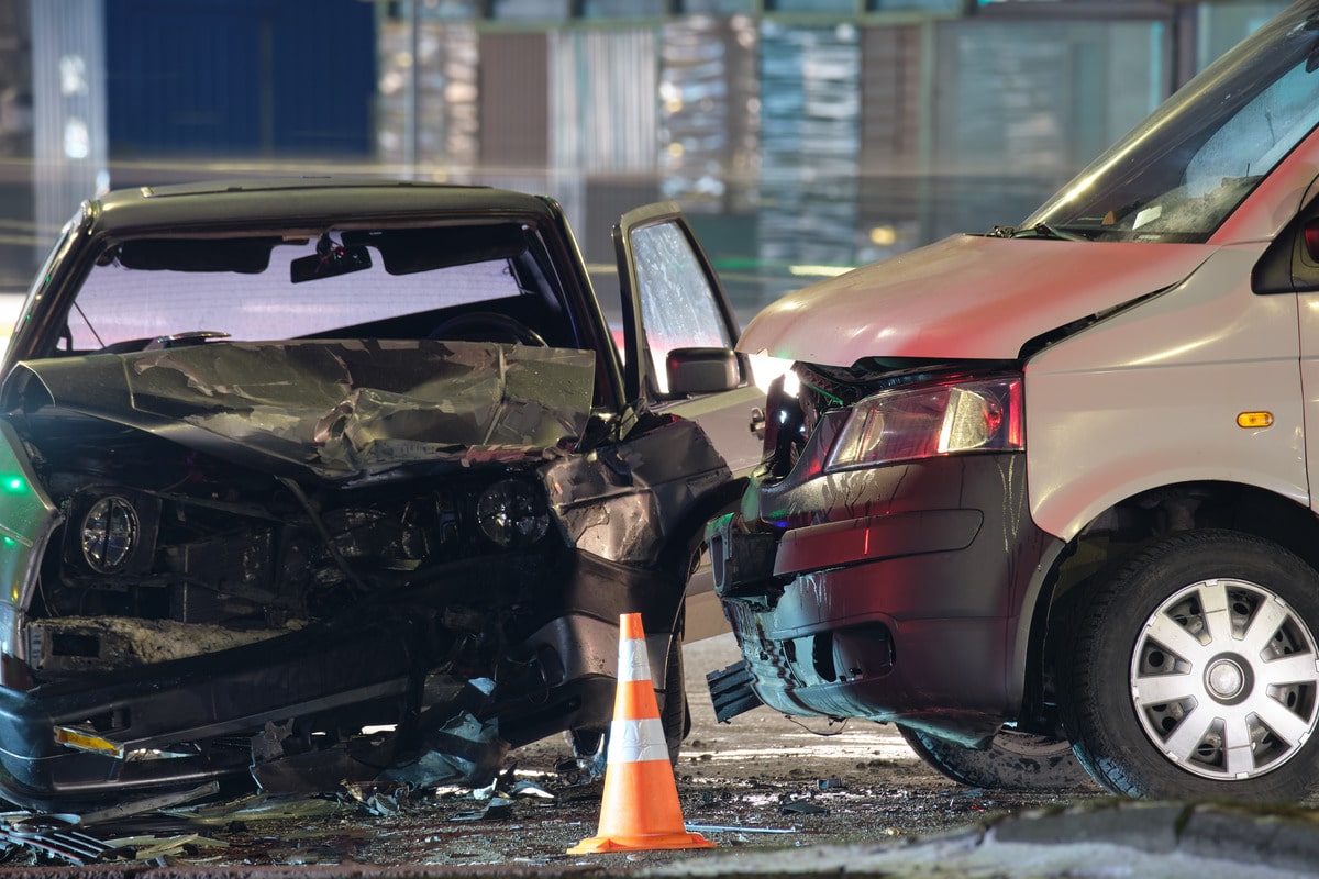 Nighttime auto accident showing catastrophic damage, used for personal injury law, emergency services, or collision repair businesses