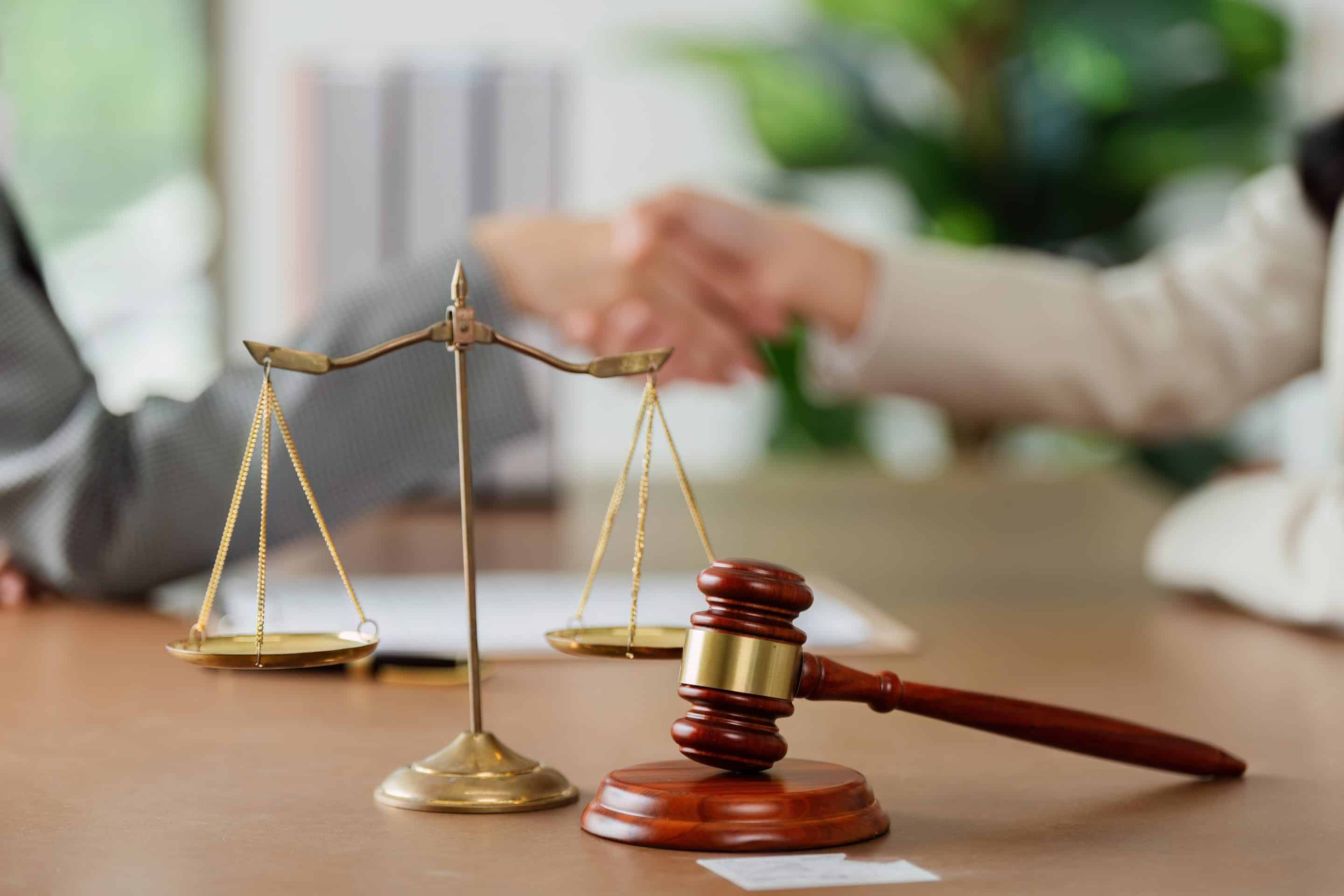 A gavel with a lawsuit document on a table