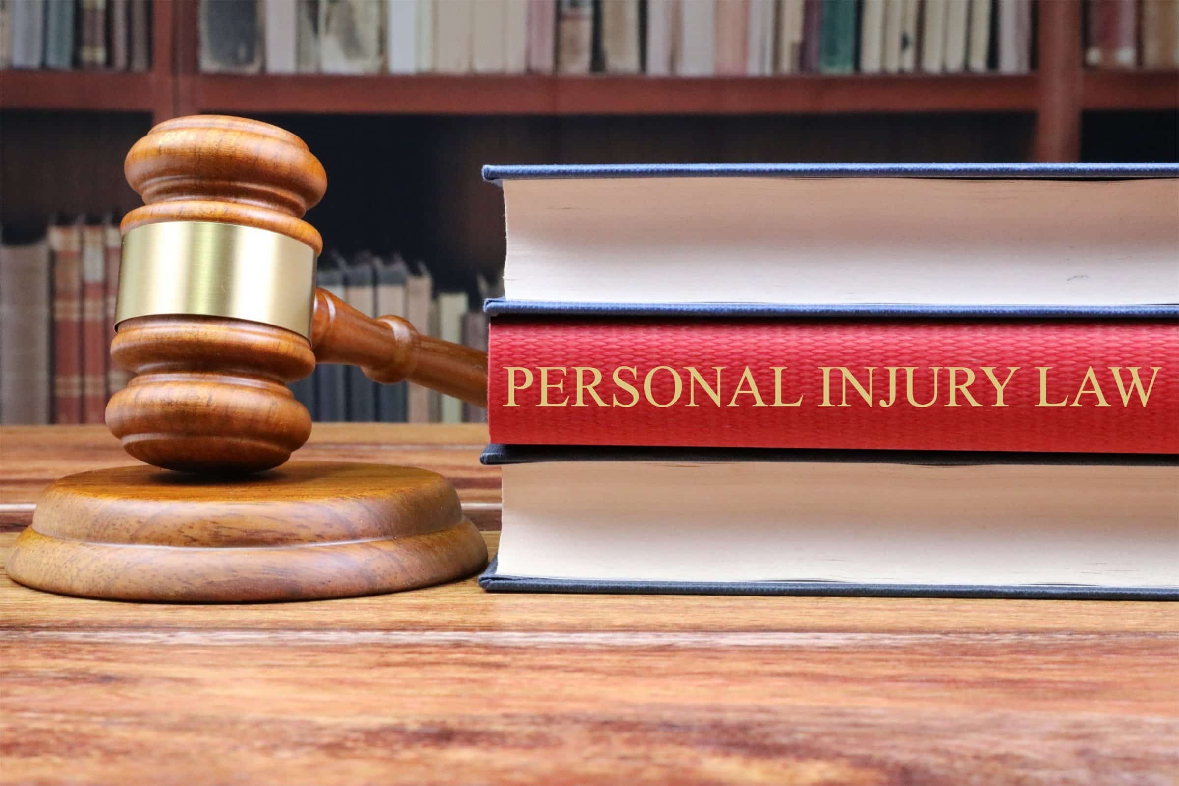 Personal Injury Law book and judge's gavel, representing legal services for accident claims, lawsuits, and bodily harm