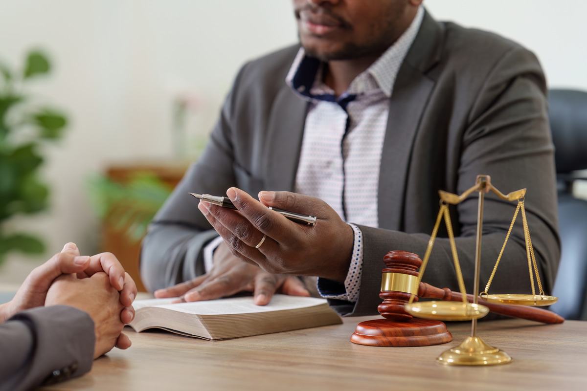 Professional legal consultation with an attorney at law featuring a gavel and scales of justice, representing expert legal advice and law firm services for clients