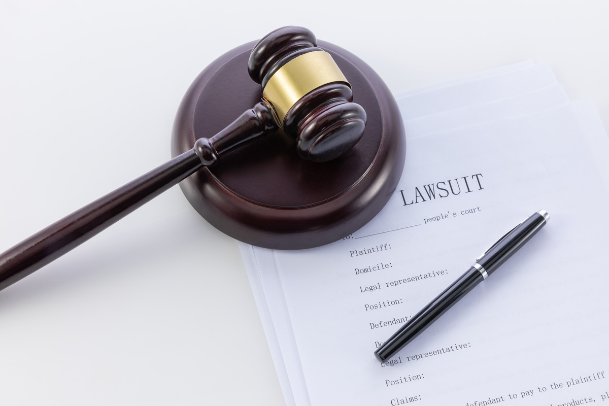Legal lawsuit filing documents with a judge’s gavel, representing civil litigation, attorney services, and the process of filing a claim in court