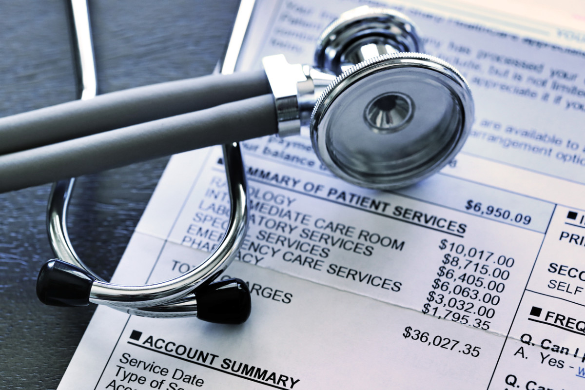 High medical bills and patient account summary with a stethoscope, representing medical debt, healthcare costs, and personal injury compensation claims