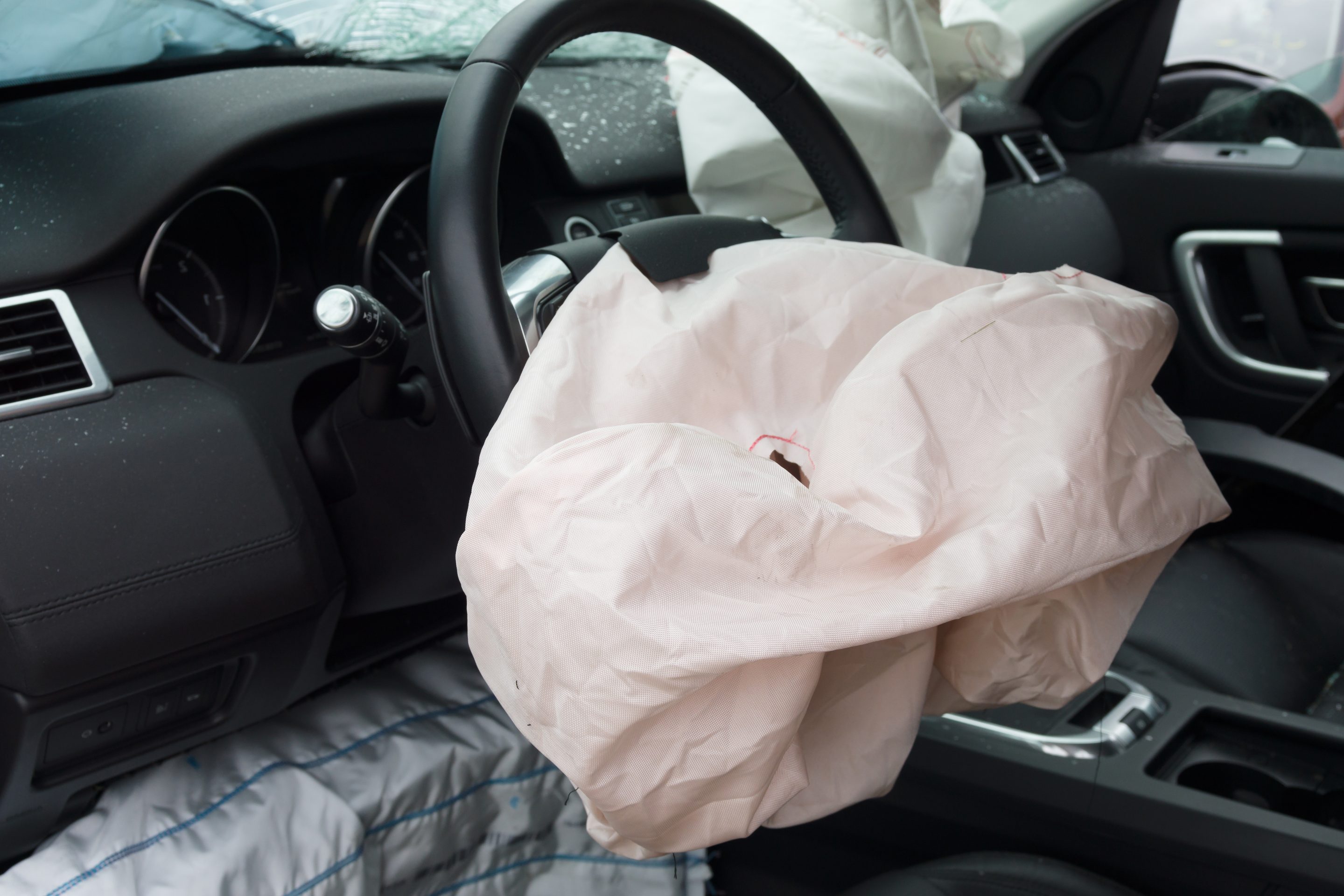 Deployed steering wheel airbag in a car after an accident, representing automotive safety, personal injury insurance claims, and vehicle collision recovery