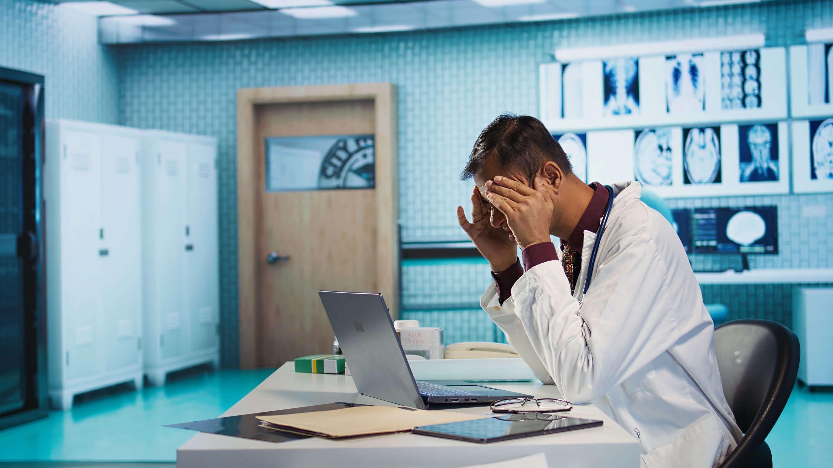 Stressed physician in a hospital setting, representing doctor burnout, medical negligence due to fatigue, and healthcare provider liability